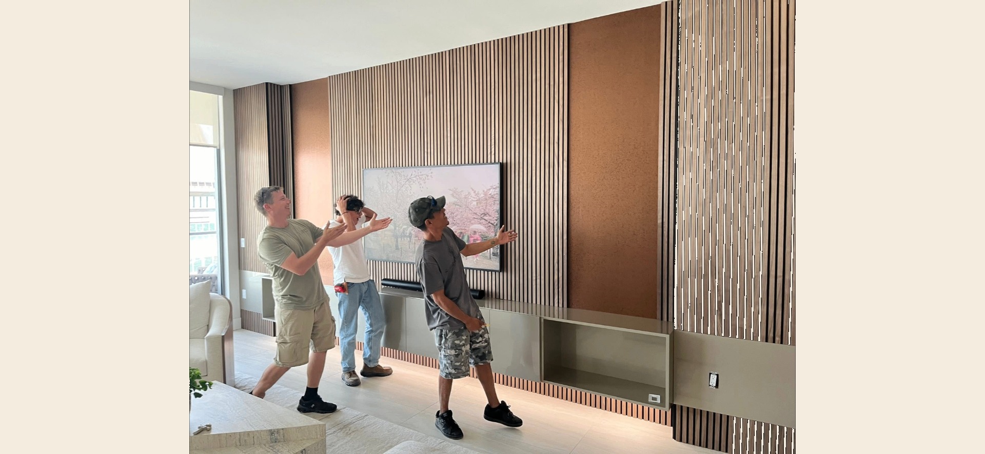 Custom vertical slat wall installation with TV mount and floating cabinetry
